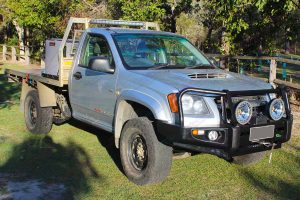 Front right view of a Silver RC Holden Colorado single cab fitted with an 45mm Tough Dog lift kit, Ironman 4x4 bullbar, winch, light bar and spotlights