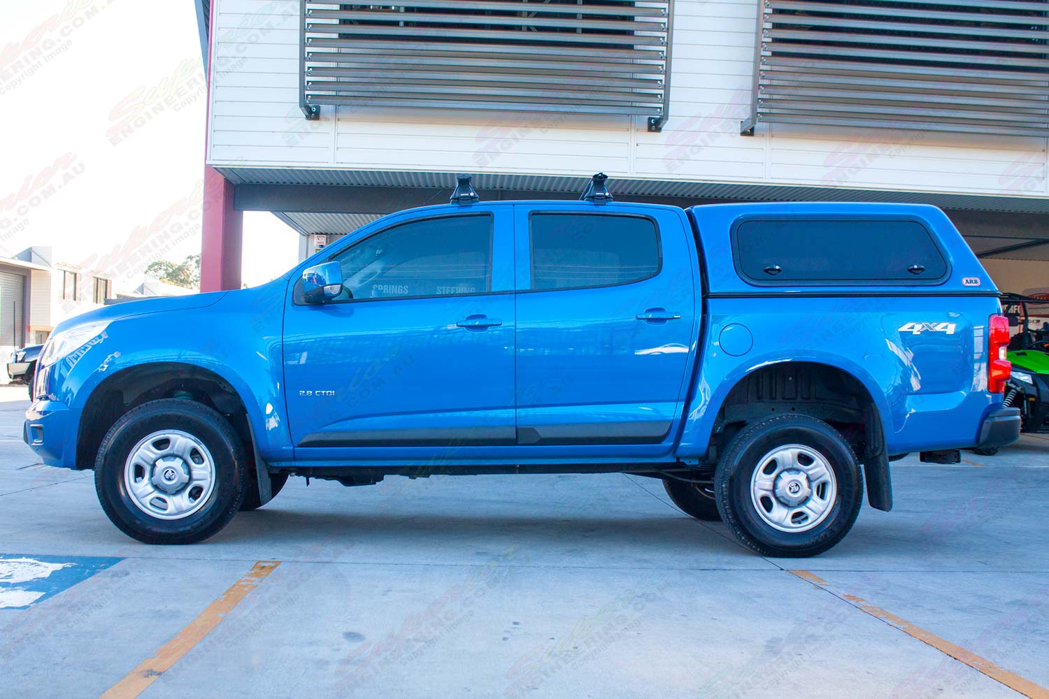 Left side profile view of a blue RG Holden Colorado fitted with the Superior 2" lift kit