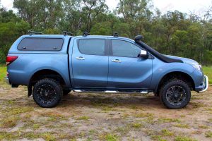 Right side profile view of a blue Mazda BT-50 dual cab fitted with a Superior 2" inch lift kit