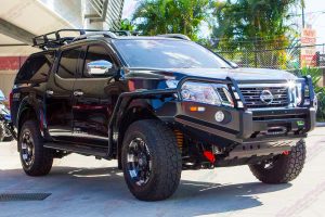 Front right view of a Black NP300 Nissan Navara dual cab fitted out with a complete range of Ironman 4x4 accessories.