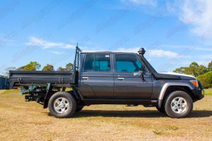 Right side view of a Brand NEW 79 Series Dual Cab Toyota Landcruiser fitted with a set of Superior Stealth Rock Sliders