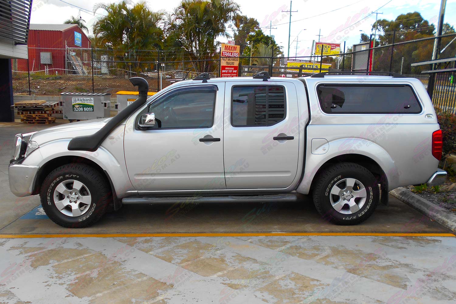 Left side view of a silver D40 Nissan Navara dual cab fitted with an Ironman 4x4 Airforce Snorkel