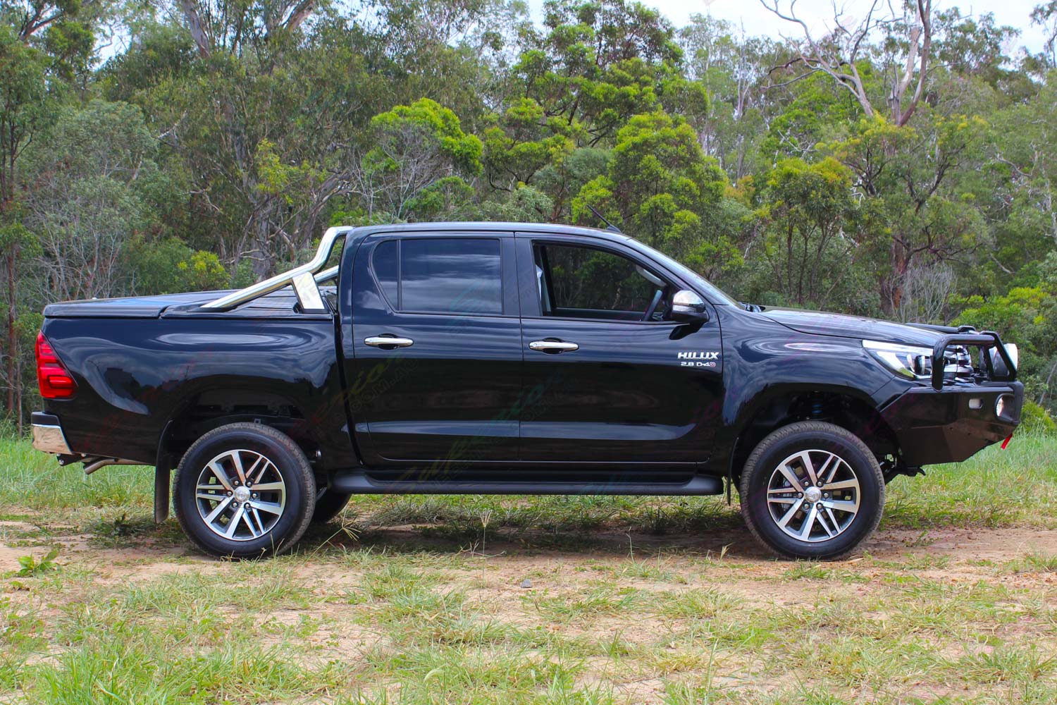 Right side view of a black Toyota Hilux Revo (Dual Cab) fitted with a premium Bilstein 2 inch lift kit