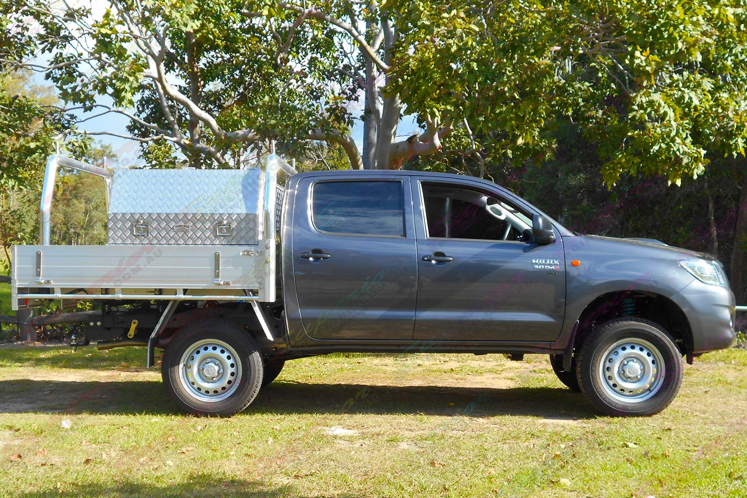 Right side view of a grey dual cab Toyota Hilux (Vigo) fitted with a heavy duty Dobinson 2 inch lift kit