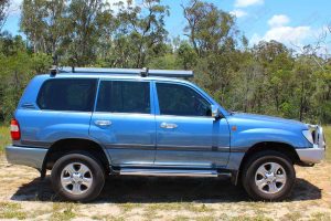 Right side view of a blue 100 Series Toyota Landcruiser after being fitted with a premium 2 inch Bilstein lift kit