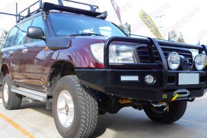 Front right view of a maroon 100 Series Toyota Landcruiser after being fitted with a heavy duty 2 inch Dobinsons 4x4 lift kit