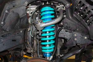 Closeup view of a Profender Adjustable Remote Reservoir Strut, Coil Spring and Superior Upper Control Arm fitted to the front of the 200 Series Toyota Landcruiser