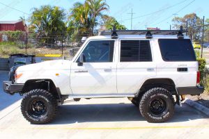 Left side view of a 76 Series Toyota Landcruiser after being fitted with a premium Superior Remote Reservoir Superflex 4 Inch Lift Kit