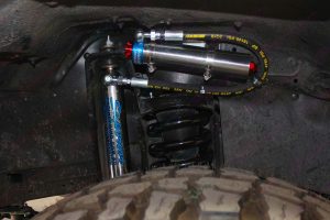 Closeup view of a single Superior remote reservoir shock fitted to a 76 Series Toyota Landcruiser 4wd