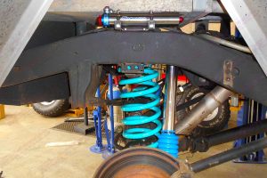 Under vehicle view of a Superior remote res shock, coil springs and control arms fitted to the rear of the 80 Series Toyota Landcruiser