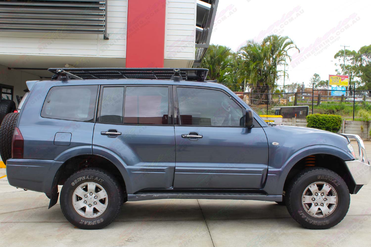 Right side view of a dark grey NP Mitsubishi Pajero wagon fitted out with a 40mm Ironman lift kit