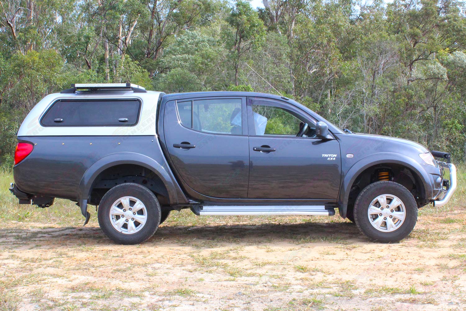 Right side view of a ML Mitsubishi Triton dual cab fitted out with a constant load 40mm Ironman lift kit