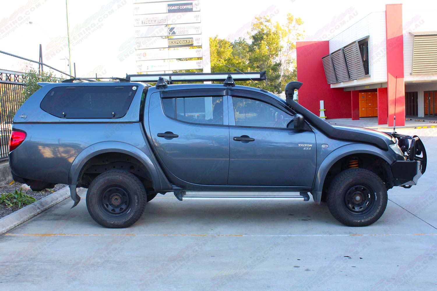 Right side view of a grey MN Mitsubishi Triton (Dual Cab) fitted with an 40mm Ironman lift kit and airforce snorkel