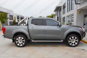 Left side view of a grey Nissan Navara NP300 after being fitted with a 35mm Ironman lift kit, Superior adjustable panhard rod, swaybar extensions & Advanti Hammer alloy wheels