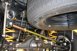 Closeup view of the Superior adjustable panhard rod, swaybar extensions and coil springs on the underside of the NP300