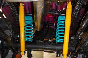 Closeup view of the heavy duty Dobinson coil springs and shocks fitted to the underside of the NP300