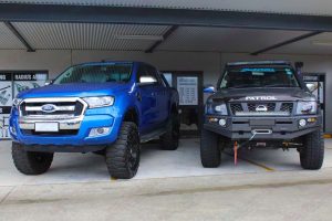 A 4 inch lifted Nissan Patrol next to the 5 inch lifted Ford Ranger at the front of the Superior 4wd retail store in Brisbane