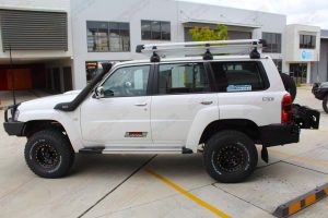 Left side view of a white Nissan Patrol Wagon after being fitted with a full custom suspension system and a range of 4x4 accessories by Superior Engineering