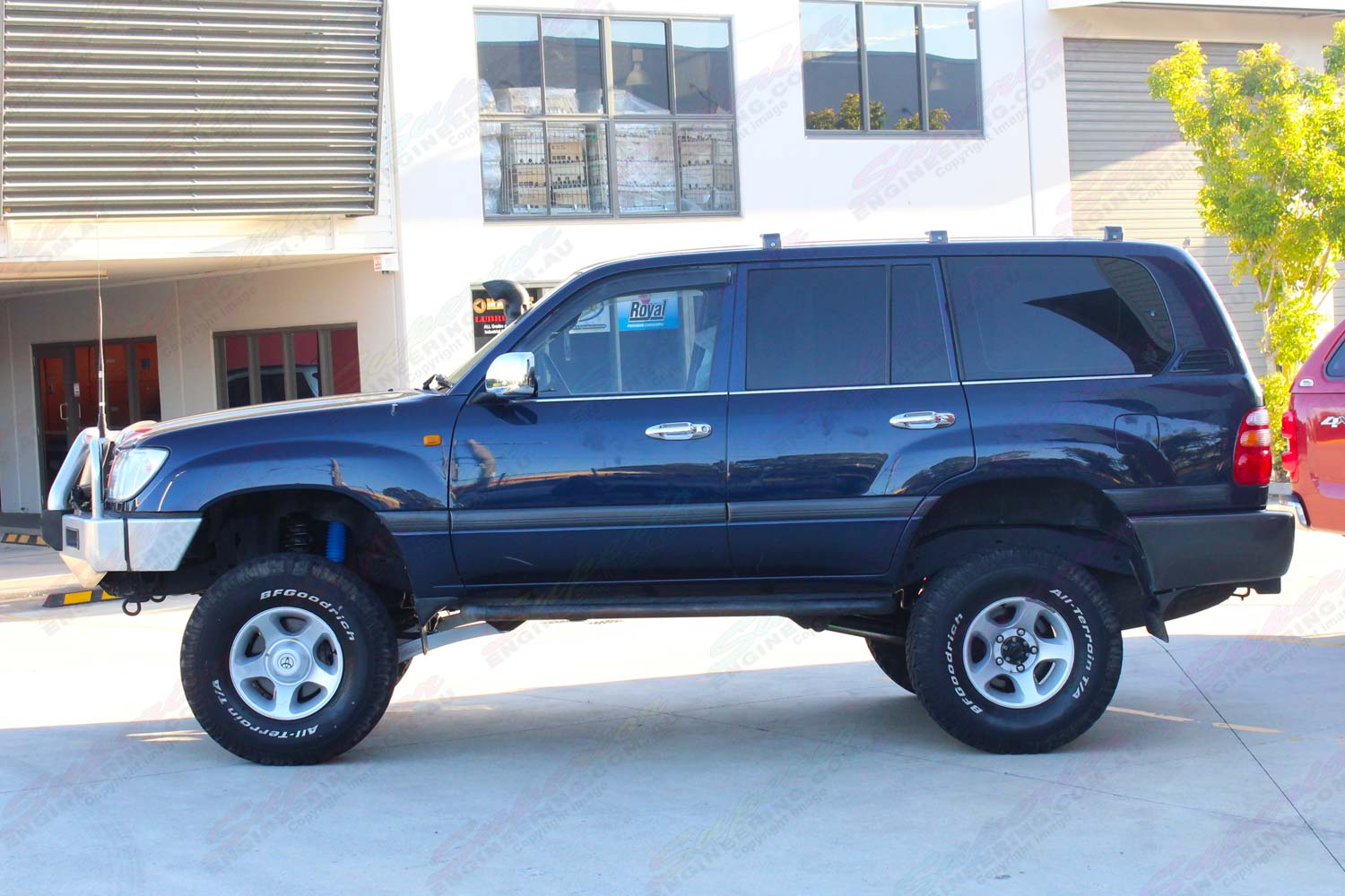 Left side view of a blue 105 Series Toyota Landcruiser after being fitted with a top of the range 4" inch lift kit