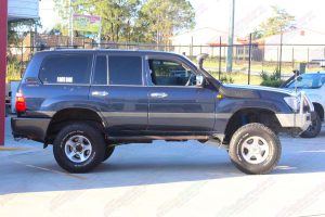 Right side view of a blue 105 Series Toyota Landcruiser after being fitted with a top of the range 4" inch lift kit from Superior