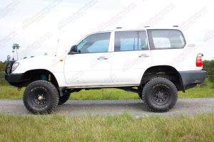 Left side view of a white 105 Series Toyota Landcruiser Wagon after being fitted with a 3 inch superflex lift kit featuring Tough Dog shocks