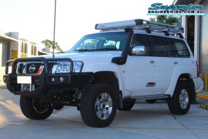 Front left view of a white GU Nissan Patrol after installing a 2 Inch Superior Remote Reservoir Lift Kit and coil tower brace at the Deception Bay 4x4 Retail Showroom