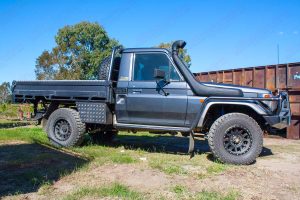 Right side view of a Grey 79 Series Single Cab Toyota Landcruiser at Superior Engineering fitted out with a new rear coil conversion kit and front suspension parts
