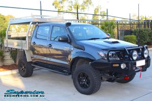 Front right view of a dual cab Toyota Hilux fitted with a complete range of 4x4 accessories and 3 inch Superior Adjustable Monotube Remote Reservoir lift kit