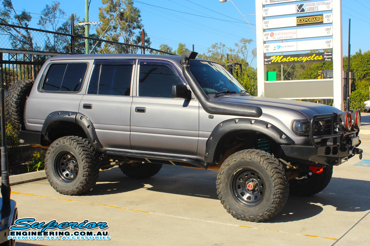 Right side view of a 80 Series Toyota Landcruiser fitted with a set of Dobinsons coil springs out the front of the Deception Bay 4wd retail store