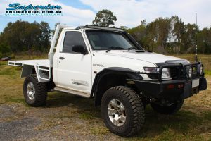 Front right view of a white GU Nissan Patrol ute after being fitted with a complete Superior Engineering 4x4 accessory and suspension fitout at their main warehouse in Burpengary