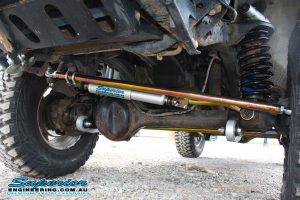 Closeup view of the heavy duty Superior Draglink, Panhard Rod, Steering Damper and Coil Spring fitted to the front of the GU Nissan Patrol ute