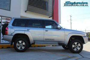 Right side view of a silver GU Nissan Patrol wagon fitted with a top of the range 2 inch Superior Remote Reservoir Lift Kit