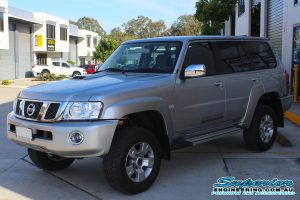 Front left view of a silver GU Nissan Patrol wagon fitted with a top of the range 2 inch Superior Remote Reservoir Lift Kit at the Deception Bay 4WD Retail Store