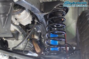 Closeup view of a single black Superior coil spring fitted to the Nissan Patrol