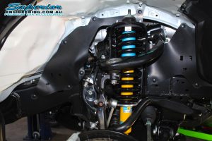 Closeup view of a single Bilstein strut and coil spring fitted to the front of a new Toyota Hilux Revo four wheel drive