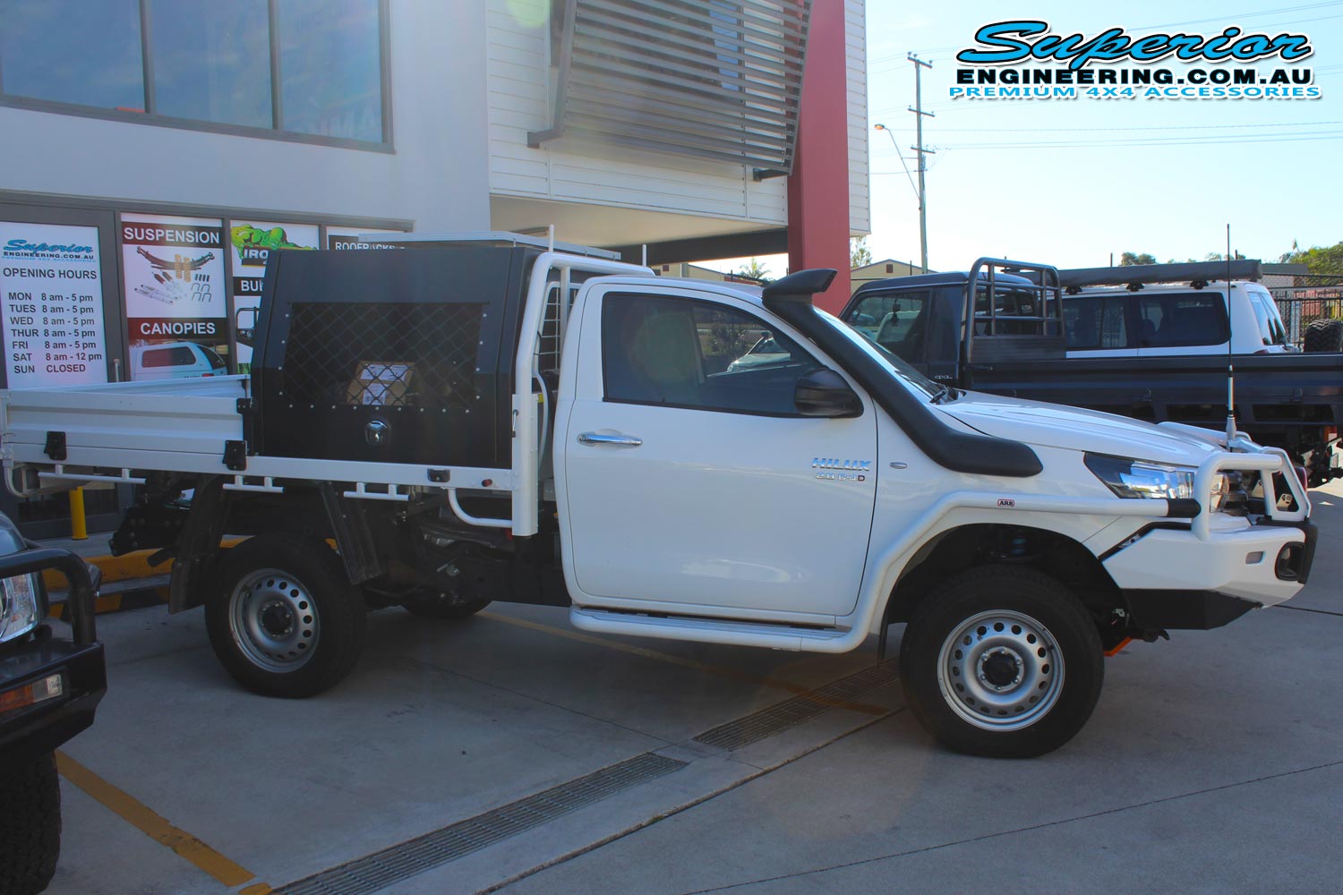Right side view of a single cab Toyota Hilux Revo fitted with a 2 inch Bilstein lift kit, Dual air control kit and Airbag Man leaf spring helper kit