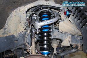 Closeup view of a heavy duty superior upper control arm, coil spring and remote res strut fitted to the front of the 200 Series Toyota Landcruiser