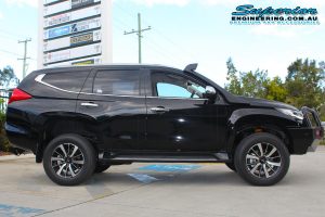 Right side view of a Black Mitsubishi Pajero Sport Wagon fitted with a 40mm Ironman 4x4 Lift Kit at the Deception Bay 4x4 Showroom