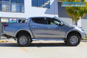Right side view of a grey MQ Mitsubishi Triton four wheel drive after being fitted with a 40mm Bilstein lift kit at the Superior Engineering 4x4 retail showroom