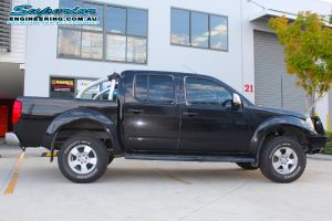 Right side view of a black dual cab Nissan Navara D40 after fitting a 40mm Ironman 4x4 lift kit and some Ironman, Legendex and SuperPro 4x4 accessories