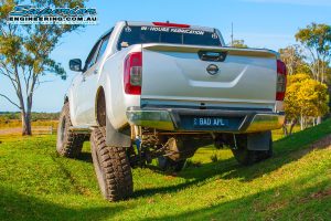 Rear view of the Bad Apple - NP300 Nissan Navara (dual cab) after fitting a big lift kit and testing out the flex on some mounds at the Superior Engineerings Burpengary warehouse