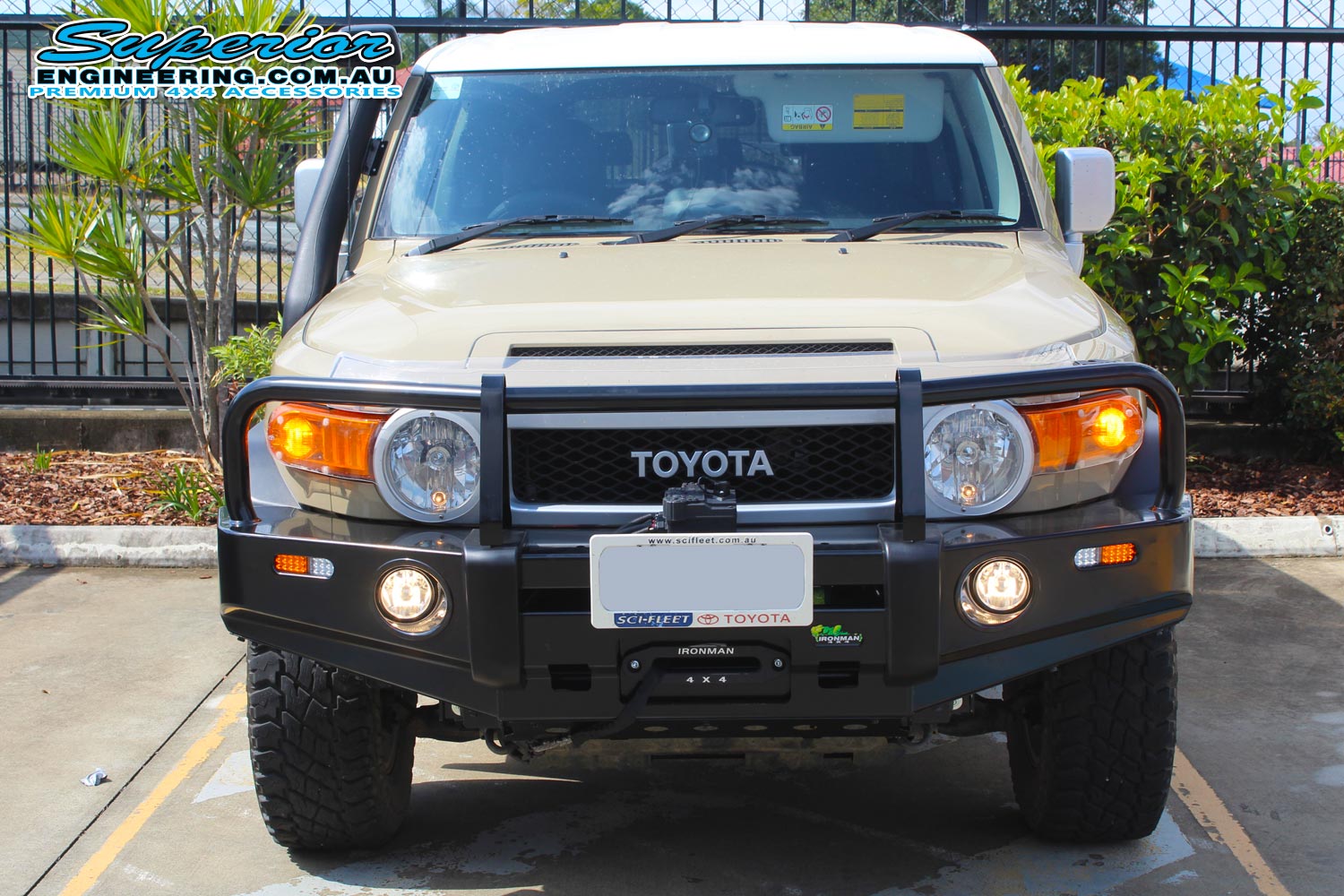 Front view of a brown Toyota FJ Cruiser fitted with a Ironman 4x4 Black Commercial Bullbar, Monster Winch and TJM Snorkel