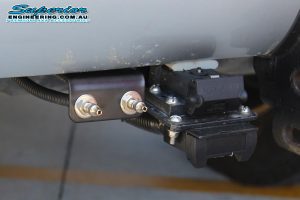 Closeup view of the air fitting valves on the rear of a 120 Prado after fitting the Airbag man coil air kit
