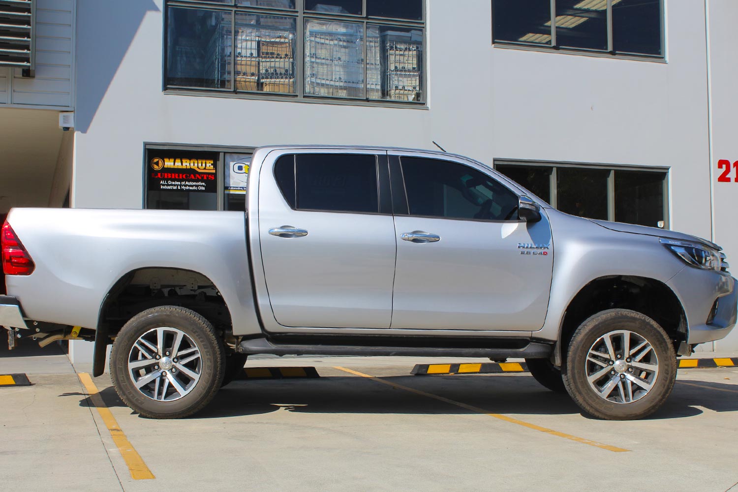 Right side view of a silver Toyota Hilux Revo dual cab fitted with a range of premium four wheel drive suspension components from Superior Engineering