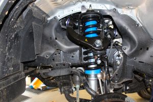 Closeup view of a single Superior Nitro Gas strut, EFS coil spring and adjustable upper control arm fitted to the Toyota Hilux Revo
