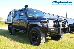 Front right view of a grey dual cab 79 Series Toyota Landcruiser after fitting the 2 inch Superior Nitro Gas Lift Kit + Allied Wheels