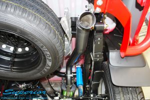 Right rear underbody view of the Legendex 3" Exhaust System fitted with Superior Leaf Spring and Nitro Gas Shock