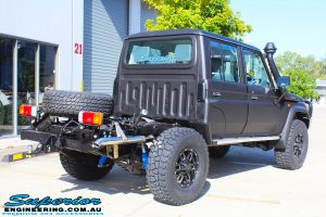 Rear right view of a Black Toyota 79 Series Landcruiser Dual Cab after fitting a Superior Remote Reservoir 2" Inch Lift Kit with Airbag Man Leaf Air Kit
