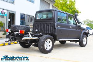 Rear right view of a Black Toyota 79 Series Landcruiser Dual Cab before fitting a Superior Remote Reservoir 2" Inch Lift Kit with Airbag Man Leaf Air Kit