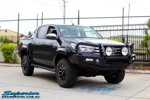 Right front side view of a Black Toyota Hilux Revo before fitting a 2" inch lift with Superior Remote Reservoir Rear Shock & Front Strut and Coil & Leaf Springs